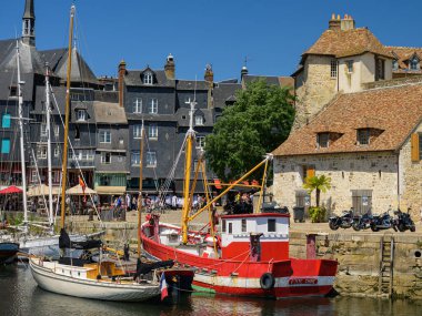 Honfleur, Fransa - 24 Temmuz 2022: Güneşli bir yaz gününde eski Honfleur limanı, mavi gökyüzü
