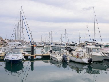 Saintes Maries de la Mer, Fransa - 9 Mart 2023: Saintes Limanı kışın Maries de la Mer, çeşitli yelkenli tekneleri, yatlar, bulutlu gökyüzü