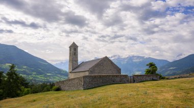 Old church of Sankt Veit am Bichl (South Tyrol, Italy) on a cloudy day in summer clipart