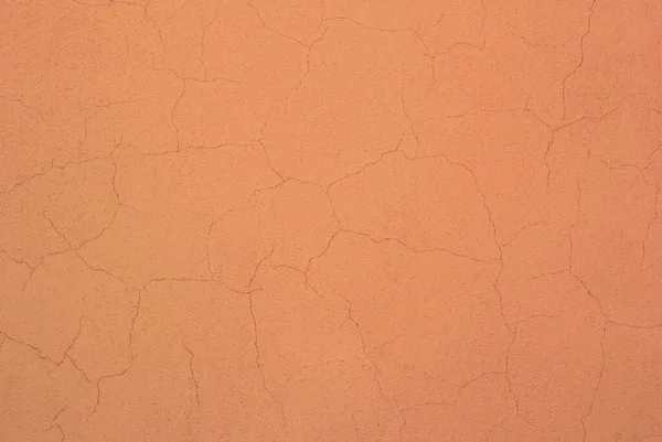 石膏の中に多くの亀裂と桃の色のコンクリート壁の写真 — ストック写真