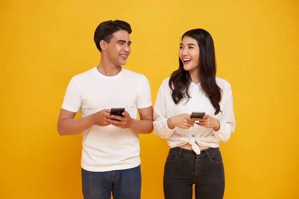 Excited Young Couple Asian Friends White Shirts Isolated Yellow Background Stock Photo