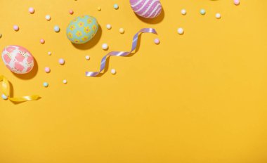 Happy easter Colourful of Easter eggs on yellow background. Greetings and presents for Easter Day celebrate time. Flat lay ,top view, copy space.