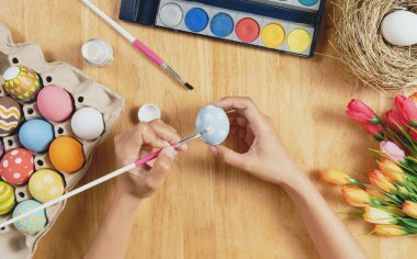 Happy easter day. Easter painted eggs on wooden rustic table for your decoration in holiday. Greetings and presents for Easter Day celebrate time. Flat lay ,top view.