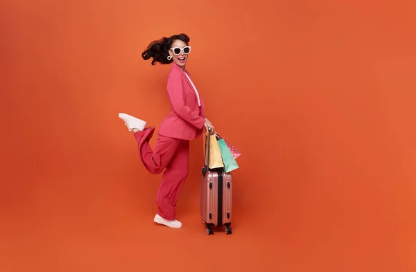Happy Young Woman Traveler Drag Luggage Shopping Bag Isolated Orange — Photo