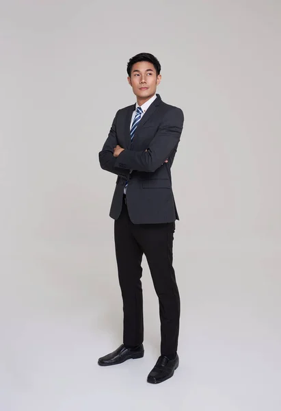 stock image business, people good looking in studio. Full length Asian businessman in grey suit confident with crossed arms on white background. 