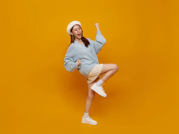 stock image Excited young asian teen female with raised hands celebrating success Portrait cheerful positive asian woman with raised hands and fists open mouth Girl get happy isolated on yellow background.