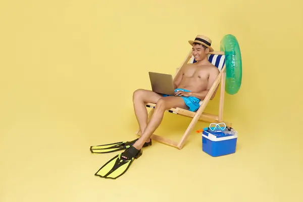 Tourist Asian Man Working Laptop Deckchair Isolated Yellow Background Summer Stock Picture