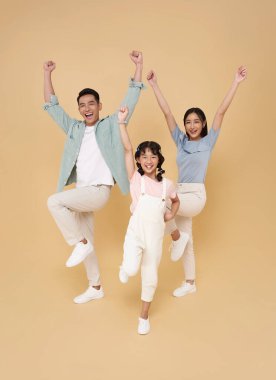 Mutlu Asyalı ebeveynler aile fotoğrafı çıplak arkaplanda el ele tutuşmayı kutluyor.