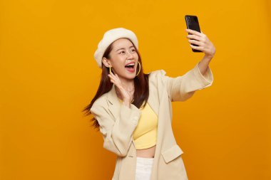 Mutlu gülümseyen Asyalı iş kadını 20 'li yaşlarda cep telefonu kullanıyor..