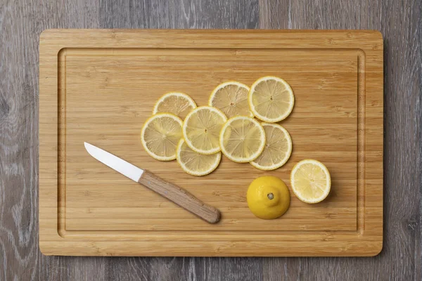 Juicy lemons cut into slices on a kitchen board, close-up, a product with a high content of vitamin C