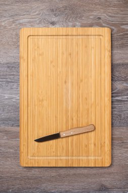 Knife on an empty kitchen board, kitchen background