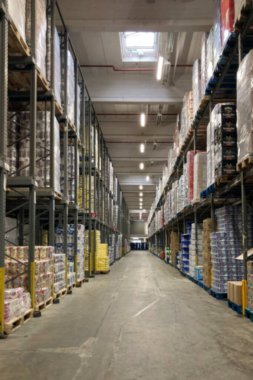 Blurred shot of warehouse with racks filled with goods and copy space for text