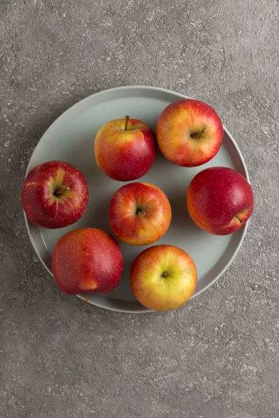 Stock image Ripe apples close-up on a gray platter. Fruit harvest, diet food