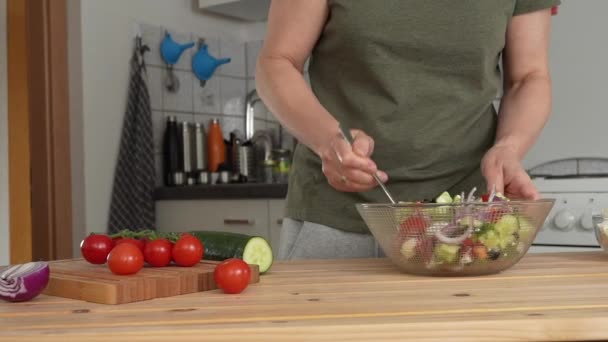 Женщина Добавляет Оливковое Масло Смешивает Греческий Салат Домашней Кухне — стоковое видео