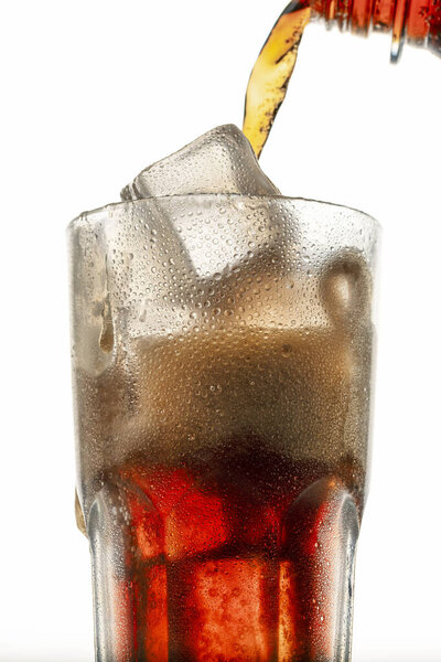 chilled cola pouring into glass, frozen motion, macro