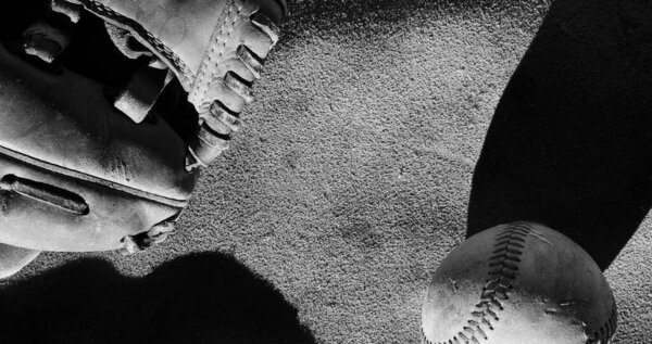 black and white image of baseball ball and glove