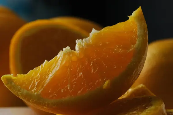 Close up of orange fruit slice on blurred background