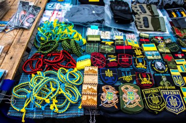 Ukrayna 'da Kyiv sokaklarında satılan dekoratif nesneler, birim yamaları ve diğer savaş zamanı hatıraları askeri ruhun etrafında dönüyor ve insanlar tarafından Rusya' ya karşı mevcut savaşta hatıra olarak alınıyor.. 