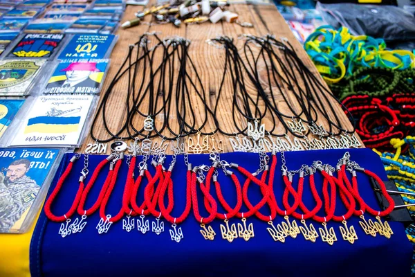 stock image Decorative objects sold on the streets of kyiv in Ukraine, unit patches and other wartime memorabilia revolve around the military spirit and are bought by people as souvenirs on the current war against Russia. The vendors, who have sold  trinkets on 