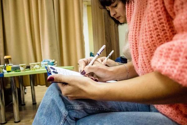 stock image Refugees who take part in a meeting, these people are colateral victims of the war and are now living at Dnipro Caritas refugee center. Caritas provides humanitarian aid and supports communities affected by the long-term impacts of the conflict