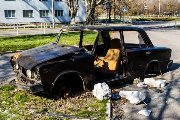 stock image Car that completely destroyed on the streets of Kherson. Russian shelling of the city is constant and civilians are prime targets.