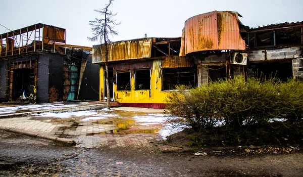 stock image The buildings as well as the businesses were badly damaged by the bombardments during the battle of Lyman which followed the Russian invasion. Civilians are targets, these are war crimes.