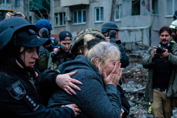 A woman is crying because a S300 russian missile has just hit the apartment where her family lived. The damage is considerable and many victims are still under the rubble. Civilians are prime targets.