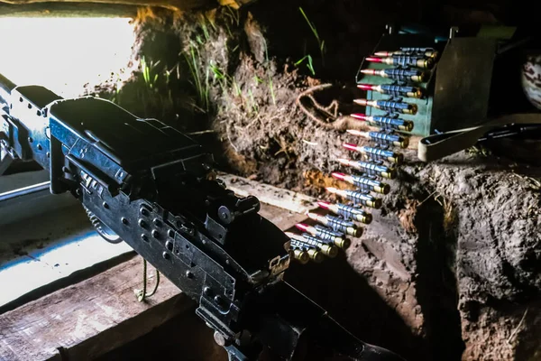 stock image Machine gun of Ukrainian serviceman of the 209th Battalion of the 113th Kharkiv Defense Brigade. The job of this brigade is to hold the position right in front of the Russian army and repel all enemy attacks.