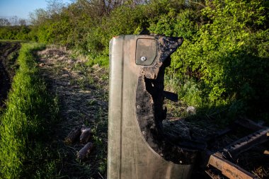 Ukraynalı askerler, Bakhmut yakınlarındaki bir ormanın kenarındaki savaş bölgesinde top atışları sonucu hasar gören bir arabayı yüklüyorlar. Askerler tekrar kullanılabilmesi için aracın motorunu kurtarmayı planlıyorlar..