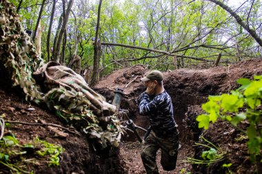 28. Topçu Taburu 'ndan Ukraynalı asker Bakhmut yakınlarındaki ormanın sıfır noktasında bir Rus hedefine 120 mm' lik havan topu atıyor. Rus ve Ukrayna orduları Donbass 'ta çarpışıyor, çatışma yoğun ve savaş şiddetleniyor. Bir...