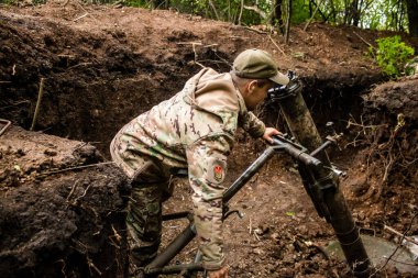 28. Topçu Taburu 'ndan Ukraynalı asker, Bakhmut yakınlarındaki ormanın sıfır hattındaki bir Rus hedefine 120 mm' lik havan topu pozisyonunu ayarlıyor. Rus ve Ukrayna orduları Donbass 'ta çarpışır, savaş şiddetlidir ve savaş şiddetlidir.