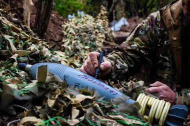 28. Topçu Taburu 'ndan Ukraynalı asker Bakhmut yakınlarındaki ormanın sıfır hattındaki Rus hedefine 120 mm' lik bir havan topu için mesaj yazıyor. Bu uygulama çok yaygın ve bu eylem eski bir geleneği yansıtıyor..