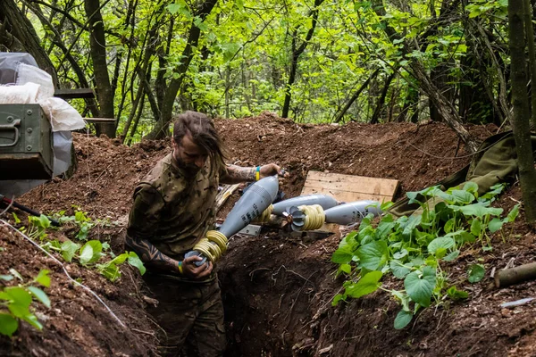 28. Topçu Taburu 'nun Ukraynalı askeri Bakhmut yakınlarındaki ormanın sıfır hattındaki bir Rus hedefine 120 mm' lik bir havan topu hazırlıyor. Rus ve Ukrayna orduları Donbass 'ta çarpışır, savaş şiddetlidir ve savaş...