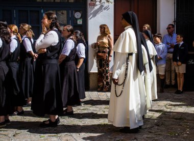 Corpus Christi geçit törenine katılan rahibeler, İsa 'nın gerçek varlığını işlemek için asırlık bir Katolik inancı geleneği. Eski Carmona kasabasının dar sokaklarında dini törenler düzenlenir.