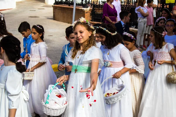 stock image Carmona, Spain - June 11, 2023 Young children participating in the feast of Corpus Christi. The procession takes place in the old town of Carmona which is reputed to be one of the most religious towns in Spain