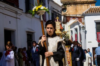 Corpus Christi geçit törenine katılan Katolik cemaatinden bir çocuk. İsa 'nın gerçek varlığını işlemek için asırlık bir Katolik inancı geleneği. Eski Carmona kasabasının dar sokaklarında dini törenler düzenleniyor.