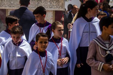 Corpus Christi geçit törenine katılan Katolik cemaatinden bir çocuk. İsa 'nın gerçek varlığını işlemek için asırlık bir Katolik inancı geleneği. Eski Carmona kasabasının dar sokaklarında dini törenler düzenleniyor.