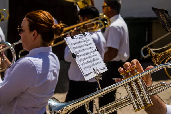 stock image Music band participating at the Corpus Christi procession, an age-old tradition of the Catholic faith to process the real presence of Jesus. Eucharistic processions take place in the narrow streets of the old town of Carmona which is reputed to be on