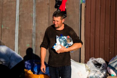 The few civilians residing in the village of Kam'yanka in Ukraine receive aid from humanitarian organizations. People live without water and electricity. The Russian army was driven out by the Ukrainians after several months of occupation. clipart
