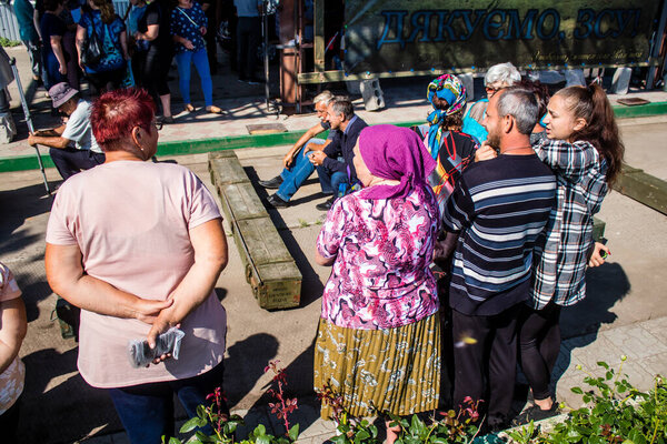 Civilians residing in the village of Kam'yanka in Ukraine. The inhabitants come together to organize themselves to rebuild their village. People live without water and electricity. The Russian army was driven out by the Ukrainians after several month