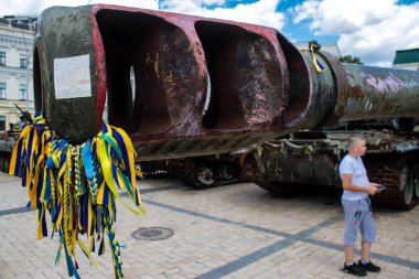 İnsanlar Ukrayna 'nın renginde bilezikler takmak için Ukrayna' nın savaşın başlangıcından beri yok ettiği Rus askeri teçhizatına geliyorlar. Bu imha edilmiş Rus askeri teçhizatının sunumu bir propaganda biçimi olarak kullanılıyor.