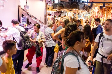 Barselona, İspanya - 28 Ağustos 2023 İspanya 'nın başkenti Barcelona' daki Boqueria gıda pazarında keyif çatan turistler.