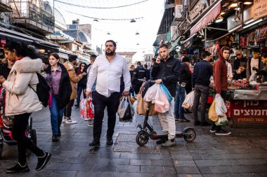 Kudüs, İsrail - 22 Aralık 2023 Mahane Yehuda Pazarı 'nda alışveriş yapan insanlar, genellikle 