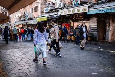 Kudüs, İsrail - 22 Aralık 2023 Mahane Yehuda Pazarı 'nda alışveriş yapan insanlar, genellikle 