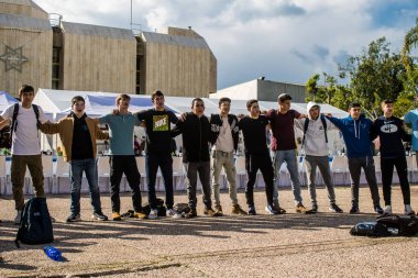 Tel Aviv, İsrail - 25 Ocak 2024 İsrailli gençler Tel Aviv 'deki Rehine Meydanı' nda hala Gazze 'de tutulan 100 rehinenin anısına şarkı söylüyorlar. İnsanlar düzenli olarak rehine ailelerini desteklemek için toplanır.