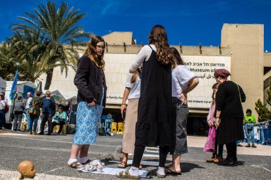 Tel Aviv, İsrail, 1 Mart 2024 İsrailliler, bugün Rehineler Meydanı olarak bilinen yerde Hamas tarafından rehin tutulan veya öldürülen çocukları resmeden bebeklere bakıyorlar.
