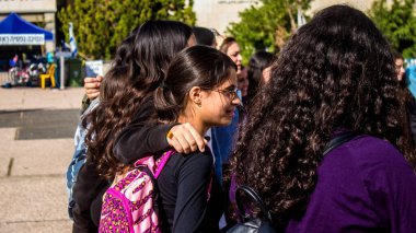 Tel Aviv, İsrail - 4 Ocak 2024 İsrailli gençler Tel Aviv 'deki Rehine Meydanı' nda hala Gazze 'de tutulan 129 rehinenin anısına şarkı söylüyorlar. İnsanlar düzenli olarak rehine ailelerini desteklemek için toplanır.