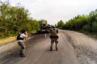 Kharkiv, Ukrayna Cephesi, 2 Haziran 2024 Joseph Roche ve Nicolas Cleuet, Kharkiv 'in kuzeyindeki Rus taarruzu sırasında imha edilen bir Rus saldırı tankını fotoğraflıyorlar.