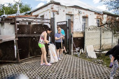 Derhachi, Ukrayna, 27 Haziran 2024 Derhachi kasabasındaki yıkılmış evlerin sakinleri Rus kuvvetlerinin güdümlü hava bombasıyla yaptığı saldırının ardından enkazı temizledi..