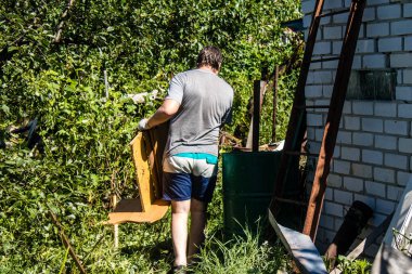 Derhachi, Ukrayna, 27 Haziran 2024 Derhachi kasabasındaki yıkılmış evlerin sakinleri Rus kuvvetlerinin güdümlü hava bombasıyla yaptığı saldırının ardından enkazı temizledi..